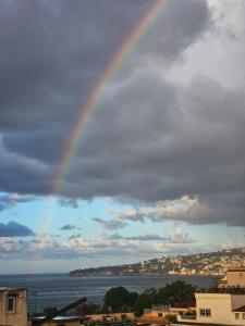 a rainbow in the sky over the water at La casa di Nettuno in Naples