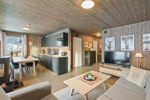 a living room with a couch and a table at Cozy Apartment close to Hovden alpine centre in Hovden