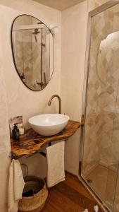 a bathroom with a sink and a glass shower at Suite Atelier Arringo in Ascoli Piceno