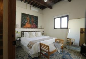 Postel nebo postele na pokoji v ubytování Orchid House San Miguel de Allende