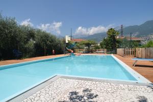 a person is jumping into a swimming pool at Agritur il Torchio in Arco