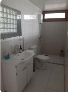 a white bathroom with a sink and a toilet at ida bay doğa evleri in Edremit