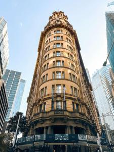 a tall building in the middle of a city at Radisson Blu Plaza Hotel Sydney in Sydney