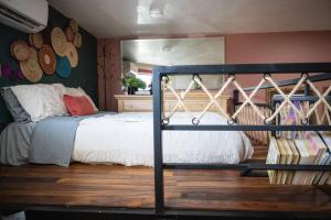 a bedroom with a bed in a room at “Encantador Loft” - en el corazón de San Pedro in Guadalajara +23 photos