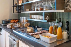 a kitchen with a counter with food on it at Best Western Bourgoin Jallieu in Bourgoin
