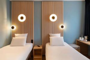Letto o letti in una camera di Best Western Bourgoin Jallieu