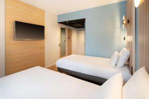 Letto o letti in una camera di Best Western Bourgoin Jallieu