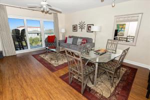 a dining room with a glass table and chairs at SeaCrest 514 condo in Fort Walton Beach