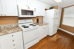 a kitchen with white appliances and a white refrigerator at SeaCrest 514 condo in Fort Walton Beach