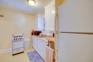a kitchen with white cabinets and a refrigerator at Cozy Billings Apartment about 1 Mi to Downtown! in Billings