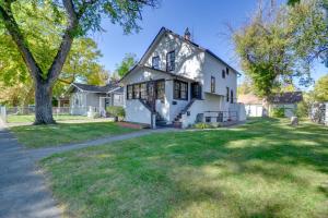 a white house with a tree in the yard at WFH-Friendly Billings Apt about 1 Mi to Downtown! in Billings
