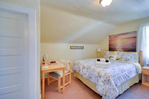 a bedroom with a bed and a table with a desk at Cozy Billings Apartment about 1 Mi to Downtown! in Billings