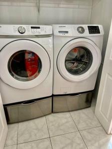 two washing machines sitting next to each other in a room at Home Away from Home in Bluffton