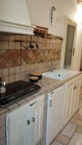 a kitchen with a sink and a counter top at Ziella Home in Ostuni