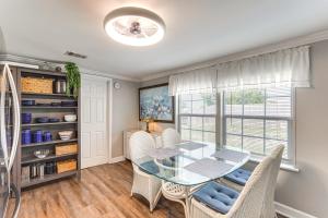a dining room with a glass table and chairs at Cottage with St Andrews Bay Views, Deck and Porch! in Panama City