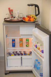 an open refrigerator with food and a plate of food at Yasmin Pyramids Boutique in Cairo