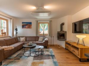 a living room with a couch and a table at Haus Ganbei L in Donnersbachwald