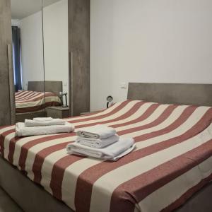 a hotel room with a bed with towels on it at Venezia Beach in Chioggia