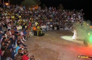 a crowd of people watching a woman in a show at Olympus Beach Aigani Family House in Aigáni