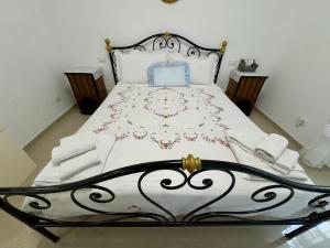 a bedroom with a bed with a white bedspread at Azadi Center Apartment in Rome