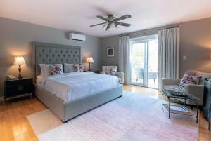 a bedroom with a bed and a ceiling fan at Lantern Hill & Hollow in Ingonish Beach