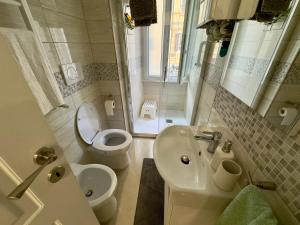 a bathroom with a sink and a toilet and a sink at Azadi Center Apartment in Rome