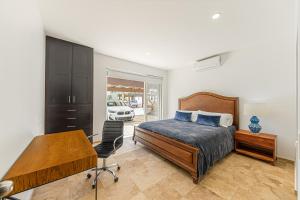 a bedroom with a bed and a desk and a chair at Cabo Villa - G3 Punta Arena - 3 Bed 2.5 Bath in Cabo San Lucas +17 photos