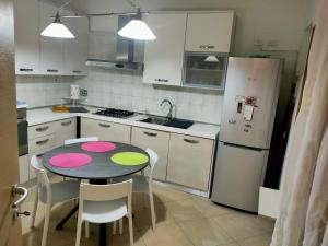 a small kitchen with a table and a refrigerator at Stefy House in Lastra a Signa