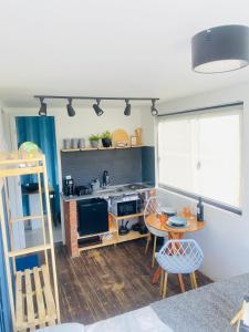 a kitchen with a table and a kitchen with a stove at Vila Eco Mobili in São Roque +41 photos