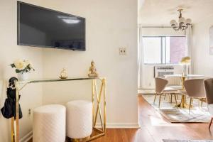 a living room with a table and a television on the wall at Apt in West New York free Parking 15 Min to Times Square in West New York