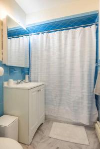 a bathroom with a toilet and a shower curtain at Apt in West New York free Parking 15 Min to Times Square in West New York