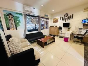 a living room with a couch and a tv at H2 Segama Backpacker in Kota Kinabalu