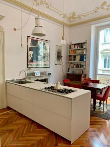 a kitchen with a white island in a living room at Apart Deluxe Casa Boffa-Costa in Turin