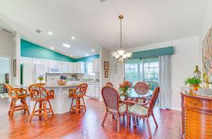 a kitchen and dining room with a table and chairs at Charming Villages Home with Lanai and Golf Cart! in The Villages