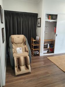 a room with a chair in a room with a closet at Luxury private guest suite in the Blue Mountains in Springwood