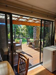 a wooden deck with a table and chairs at Heta Road B&B in New Plymouth