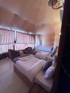 a room with two beds in a tent at Nara desert camp in Wadi Rum