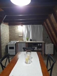 a kitchen with a table with two glasses on it at casa alpina in Navarro +7 photos