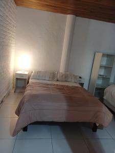 um quarto com uma cama grande com duas mesas e um candeeiro em Aires de Vida em Federación