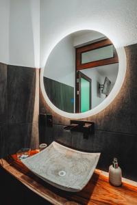 uma casa de banho com um lavatório e um espelho em New La Manzanilla Paradise Vibrant Pool Home em La Manzanilla