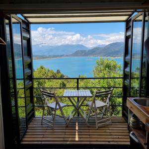 a view from the balcony of a house with a table and chairs at ECOREFUGIO in Colbún