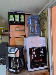 a coffee maker and a toaster sitting on a shelf at Hostal Sol y Luna 