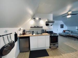 a kitchen with a sink and a stove top oven at Fin's Studio, Fundy Park in Alma