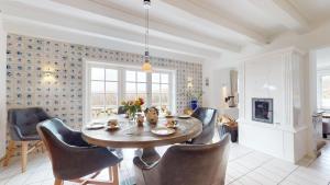 a dining room with a table and chairs at Haus Weststrand in Hörnum