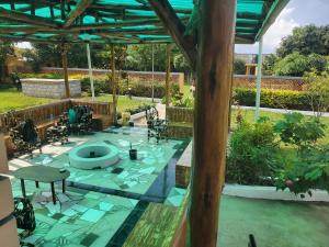 an outdoor patio with a fountain in a yard at Alice Gardens & Campsite in Entebbe