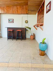 a room with a table and two stools in it at Linda Vista Hostal in Managua