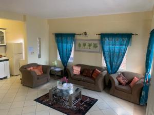 a living room with two couches and a table at Anne Marie Villas in Castries
