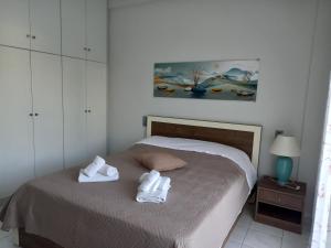 a bedroom with a bed with towels on it at Σπίτι δίπλα στην θάλασσα in Patra