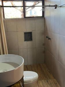a bathroom with a toilet and a tub and a sink at La Montaña Parque Natural 