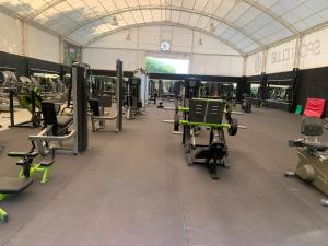 a gym with rows of exercise equipment in a building at Hotel Paraiso Inn in Tehuacán